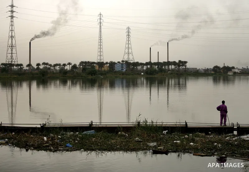 Egyptian men stand at the edge of the Nile River in Cairo, Egypt, Sunday on April 3, 2011. Photo by Wissam Nassar
