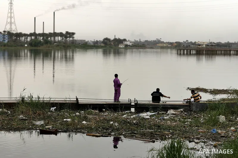 Egyptian men stand at the edge of the Nile River in Cairo, Egypt, Sunday on April 3, 2011. Photo by Wissam Nassar