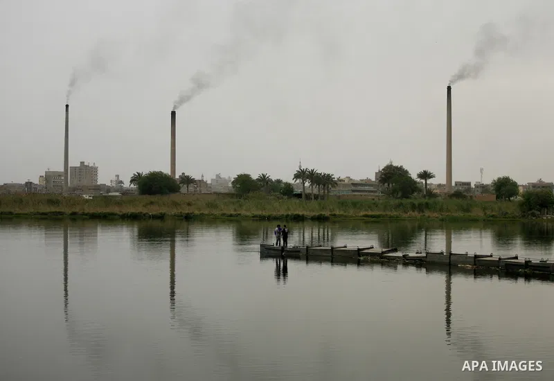 Egyptian men stand at the edge of the Nile River in Cairo, Egypt, Sunday on April 3, 2011. Photo by Wissam Nassar