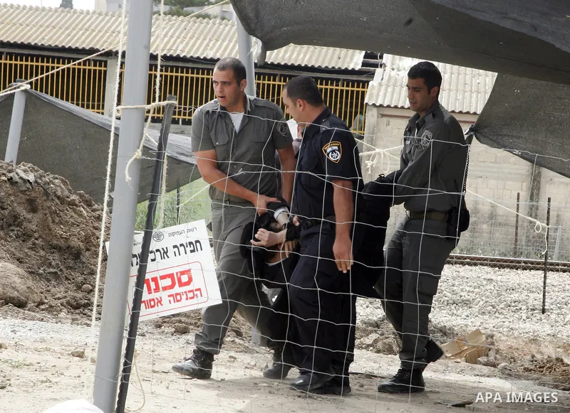 Israeli soldiers detain an Orthodox Jewish at the central Israeli town of Ramle, Sunday, April 3,2011. Photo by Mahfouz Abu Turk