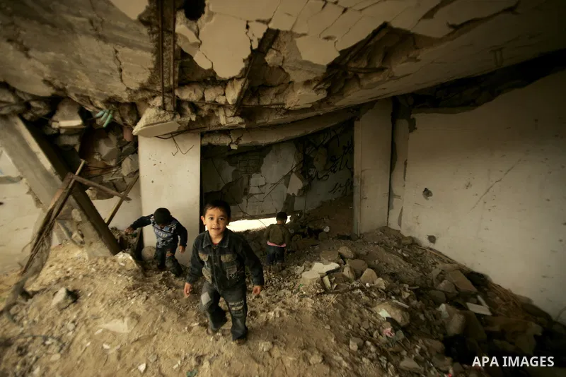 Palestinian children play on a destroyed building in Rafah, damaged during the 22-day Israeli offensive on the Gaza Strip, on April 4, 2011, a day after Israel demanded that the United Nations bin a report critical of it...