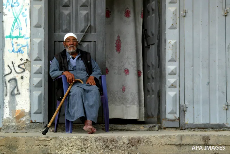 A Palestinian man sits in front of his house in Rafah in the southern Gaza Strip, on April 4, 2011, a day after Israel demanded that the United Nations bin a report critical of its deadly 2008-2009 offensive on Gaza afte...