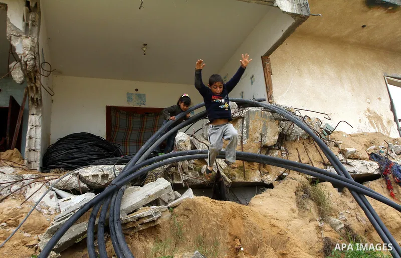 Palestinian children play on a destroyed building in Beit Lahia, damaged during the 22-day Israeli offensive on the Gaza Strip, on April 4, 2011, a day after Israel demanded that the United Nations bin a report critical...