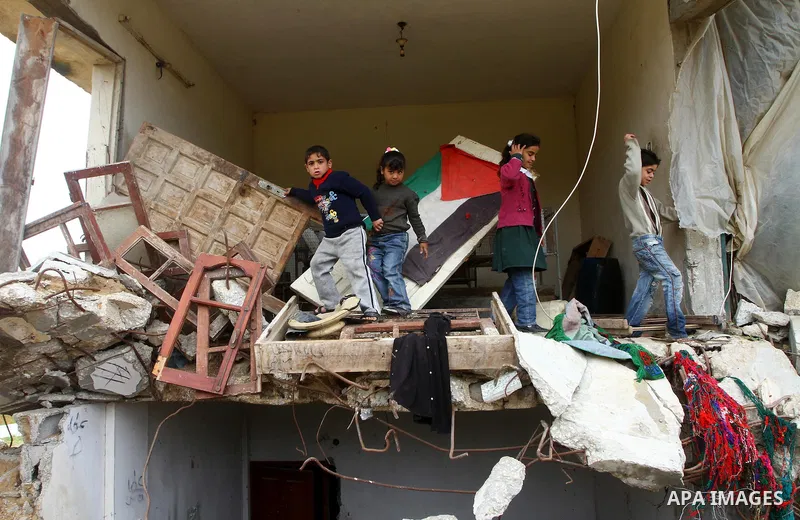 Palestinian children play on a destroyed building in Beit Lahia, damaged during the 22-day Israeli offensive on the Gaza Strip, on April 4, 2011, a day after Israel demanded that the United Nations bin a report critical...