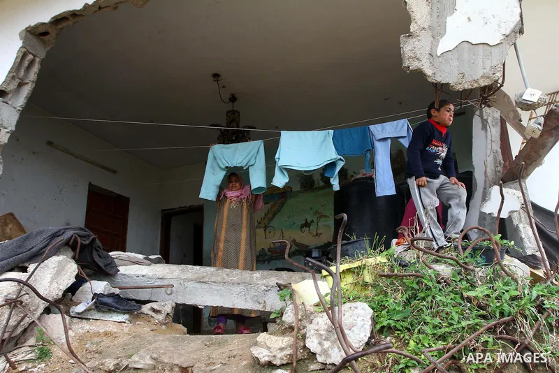 Palestinian children play on a destroyed building in Beit Lahia, damaged during the 22-day Israeli offensive on the Gaza Strip, on April 4, 2011, a day after Israel demanded that the United Nations bin a report critical...