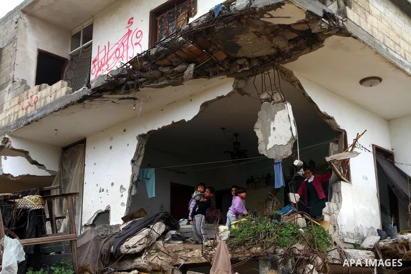 Palestinian children play on a destroyed building in Beit Lahia, damaged during the 22-day Israeli offensive on the Gaza Strip, on April 4, 2011, a day after Israel demanded that the United Nations bin a report critical...