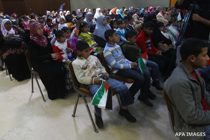 Palestinians children attend a celebration to mark the Orphan Day at al-Shawwa theatre in Gaza city on April 4,2011. Photo by Ashraf Amra