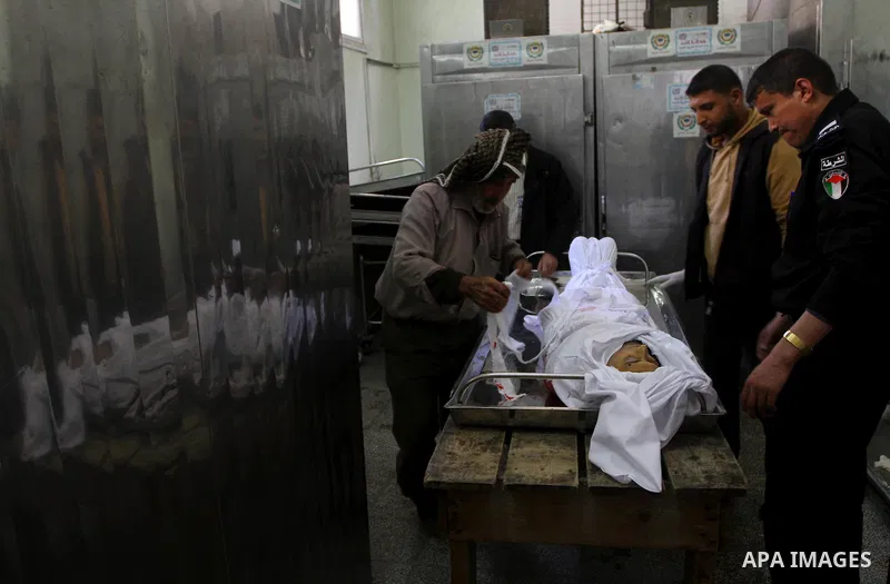 Palestinian relatives of Mohammed Shalha, 22-years-old gather around his body inside the morgue at a hospital in Gaza City on April 5, 2011. Palestinian medical officials said they had found the body in the north of Gaza...