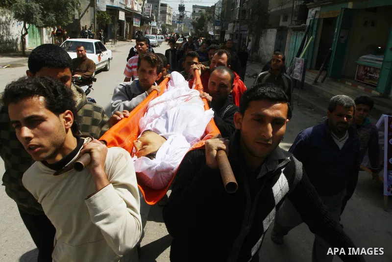 Palestinian mourners carry the body of Mohammed Shalha during his funeral in Jebaliya refugee camp, northern Gaza Strip, Tuesday, April 5, 2011. Palestinian authorities said that Shalha, 21, was killed by Israeli fire al...