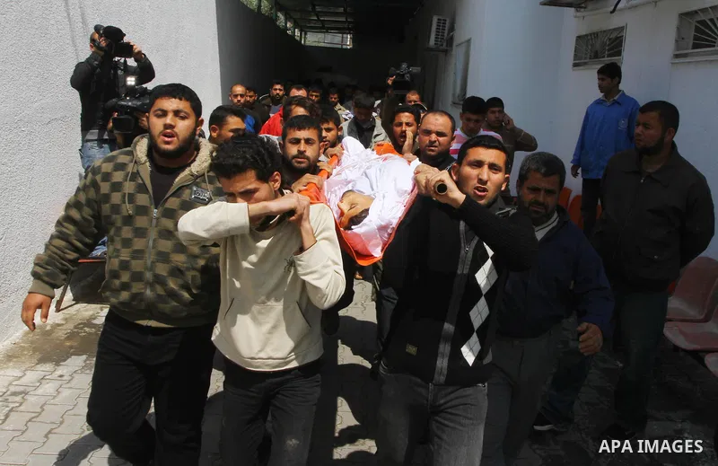 Palestinian mourners carry the body of Mohammed Shalha during his funeral in Jebaliya refugee camp, northern Gaza Strip, Tuesday, April 5, 2011. Palestinian authorities said that Shalha, 21, was killed by Israeli fire al...