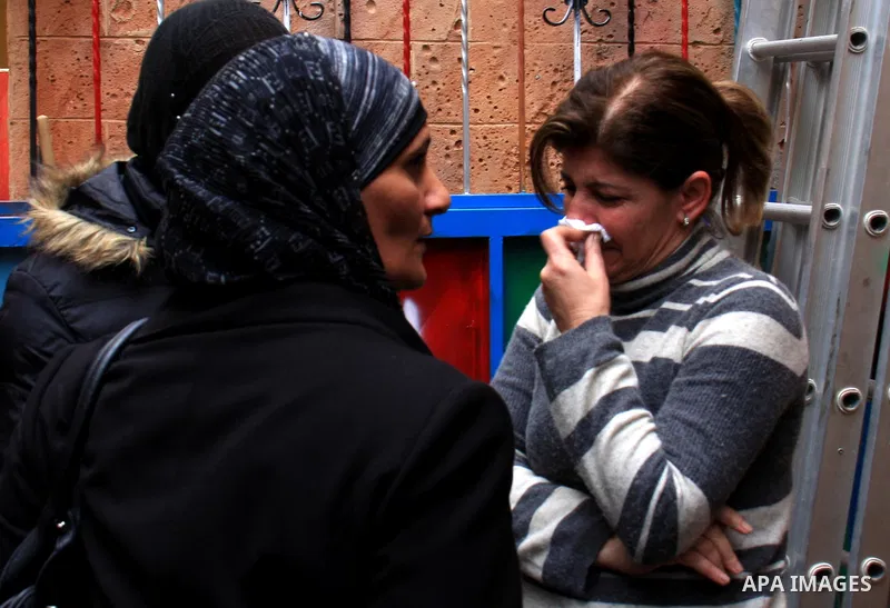 Palestinian women also workers in the Freedom Theatre in Jenin, weep on the death of Arab-Israeli actor and director Juliano Mer Khamis during a rally outside the Freedom Theatre, owned by Mer Khamis, in Jenin refugee ca...