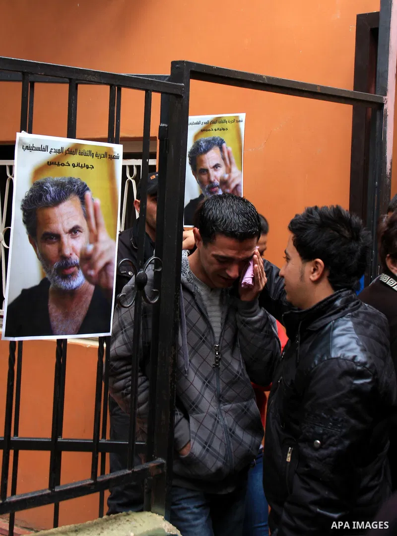 Palestinians mourn next to posters depicting Arab-Israeli actor and director Juliano Mer Khamis during a rally outside the Freedom Theatre, owned by Mer Khamis, in Jenin refugee camp, near the West Bank city of Jenin Apr...