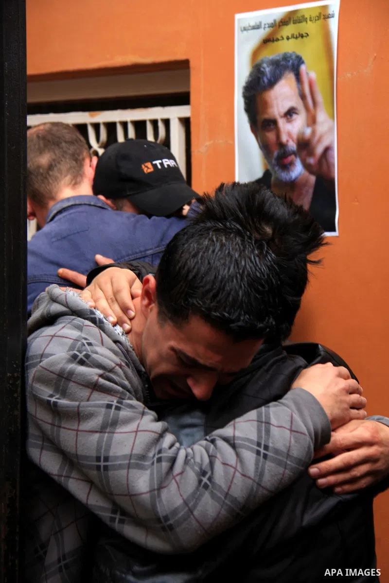 Palestinians mourn next to posters depicting Arab-Israeli actor and director Juliano Mer Khamis during a rally outside the Freedom Theatre, owned by Mer Khamis, in Jenin refugee camp, near the West Bank city of Jenin Apr...