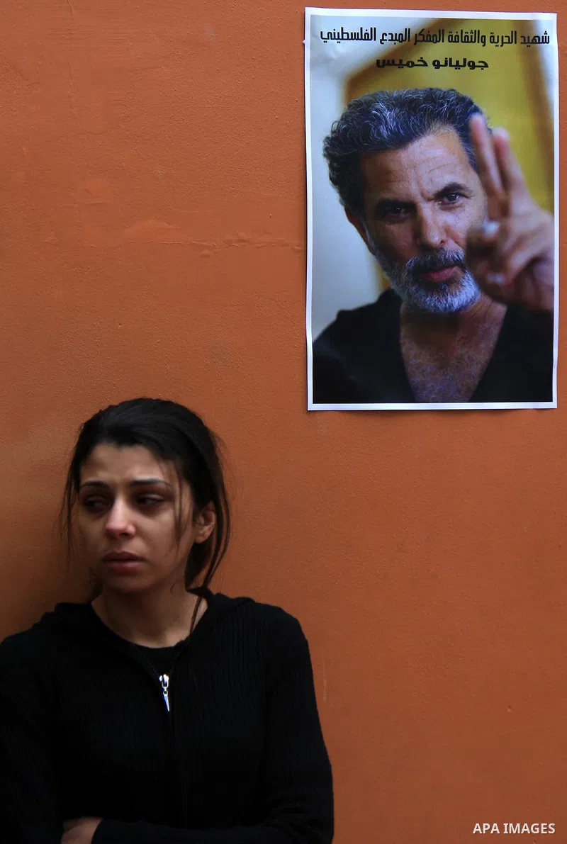 Palestinians mourn next to posters depicting Arab-Israeli actor and director Juliano Mer Khamis during a rally outside the Freedom Theatre, owned by Mer Khamis, in Jenin refugee camp, near the West Bank city of Jenin Apr...