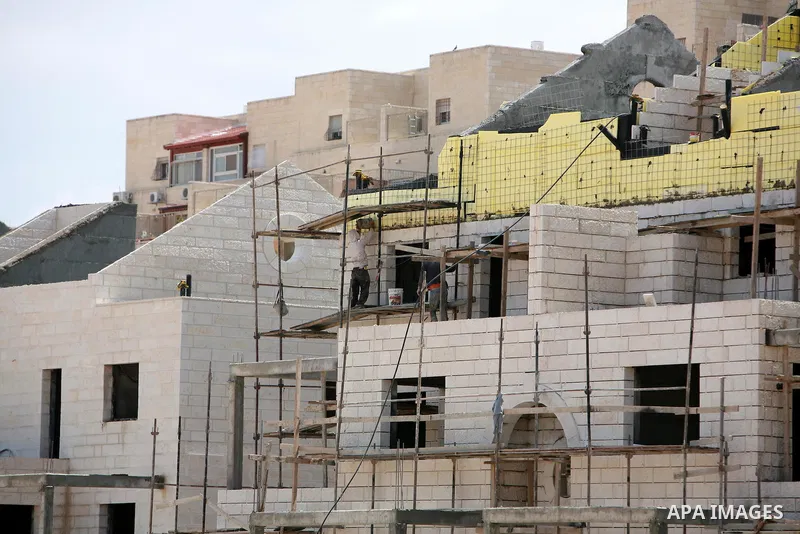 Labourers work in the jewish settlement of Pisgat Zeev in East Jerusalem, Tuesday, April 5, 2011. A group of prominent Israelis is presenting an informal new peace proposal, hoping to breathe life into deadlocked talks w...