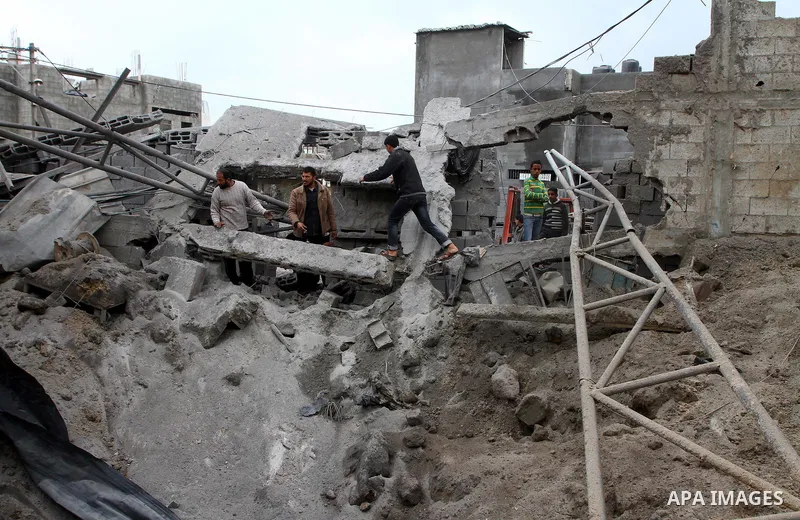 Palestinians inspect a destroyed plastics factory in Gaza City on April 6, 2011, after Israeli aircraft attacked two targets in the Gaza Strip wounding four people, among them a pregnant woman, Palestinian medics and wit...