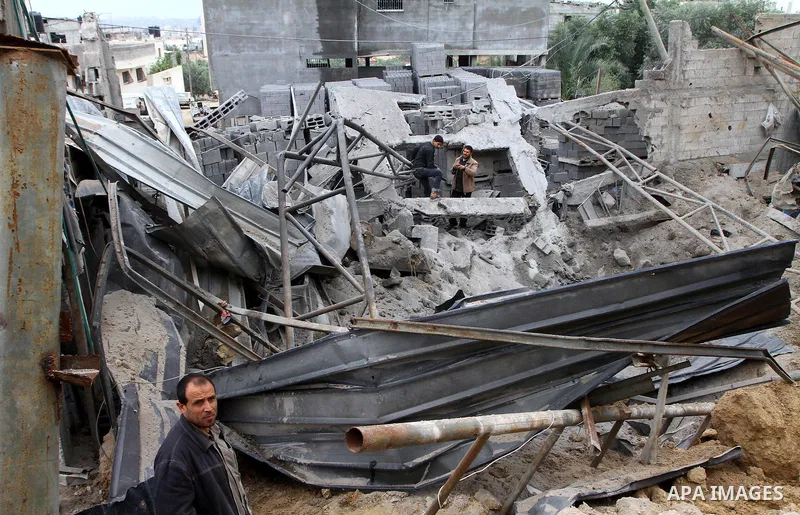 Palestinians inspect a destroyed plastics factory in Gaza City on April 6, 2011, after Israeli aircraft attacked two targets in the Gaza Strip wounding four people, among them a pregnant woman, Palestinian medics and wit...