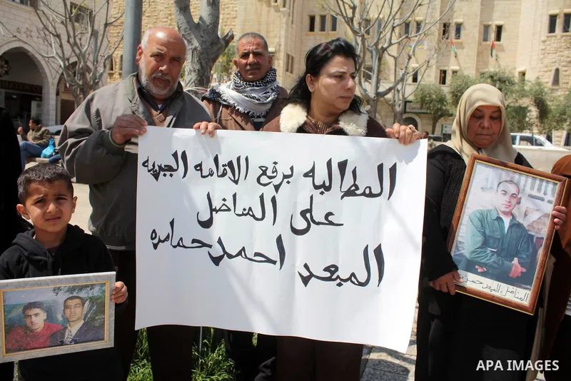 Palestinian women hold pictures of jailed relatives during a protest in the West Bank city of Bethlehem calling for their release from Israeli prisons on April 06, 2011. Photo by Najeh Hashlamoun