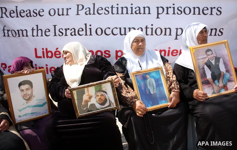 Palestinian women hold pictures of jailed relatives during a protest in the West Bank city of Bethlehem calling for their release from Israeli prisons on April 06, 2011. Photo by Najeh Hashlamoun