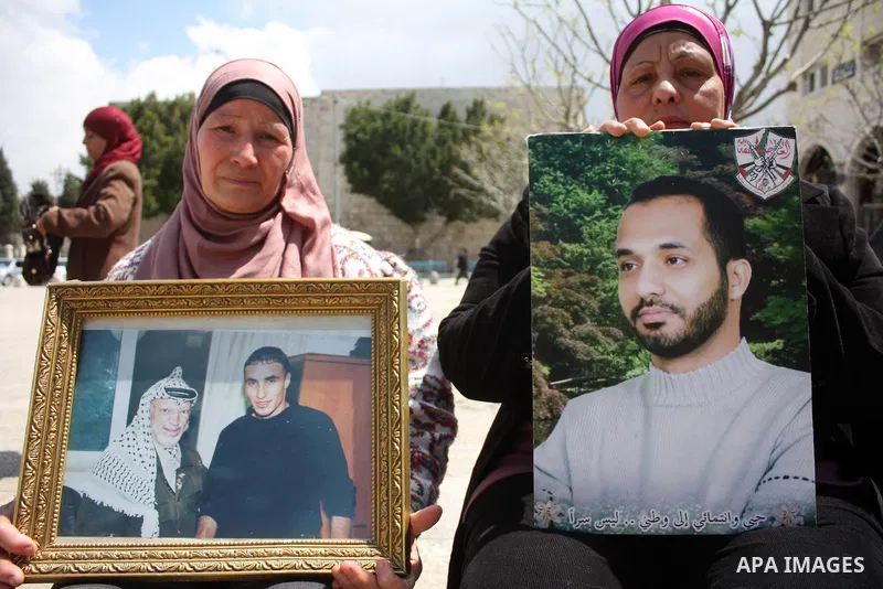 Palestinian women hold pictures of jailed relatives during a protest in the West Bank city of Bethlehem calling for their release from Israeli prisons on April 06, 2011. Photo by Najeh Hashlamoun