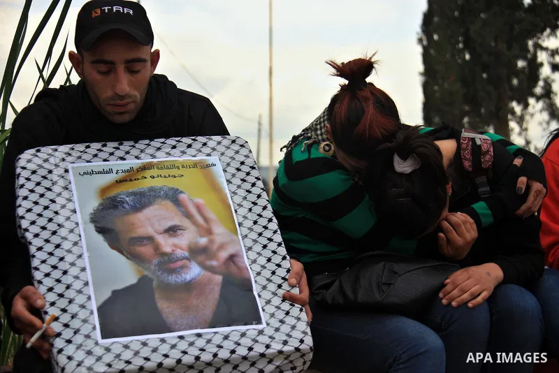 Palestinian Students of Jenin's Freedom Theater weep while waiting for the body of Arab-Israeli actor and director Juliano Mer-Khamis during his funeral at al Jalama Israeli checkpoint between Hayfa City and the West Ban...