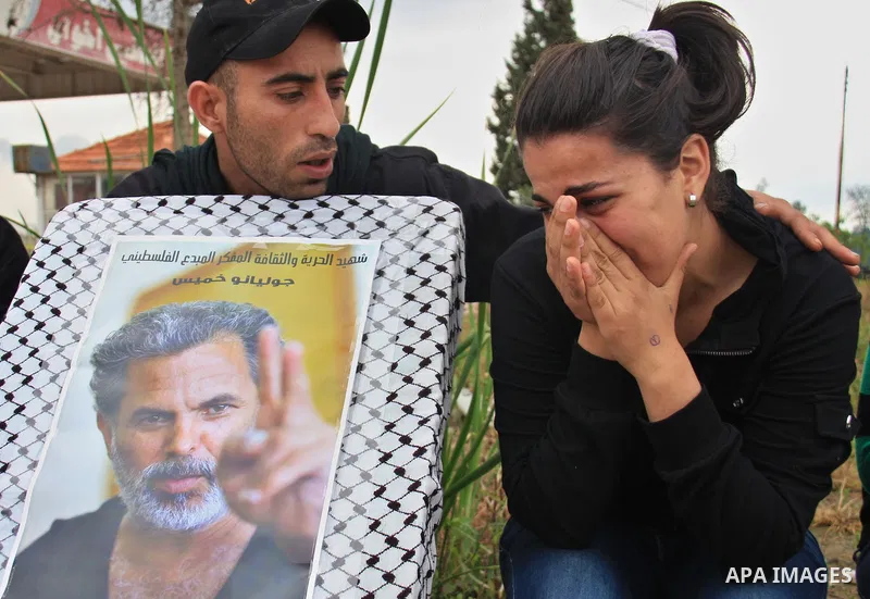 Palestinian Students of Jenin's Freedom Theater weep while waiting for the body of Arab-Israeli actor and director Juliano Mer-Khamis during his funeral at al Jalama Israeli checkpoint between Hayfa City and the West Ban...