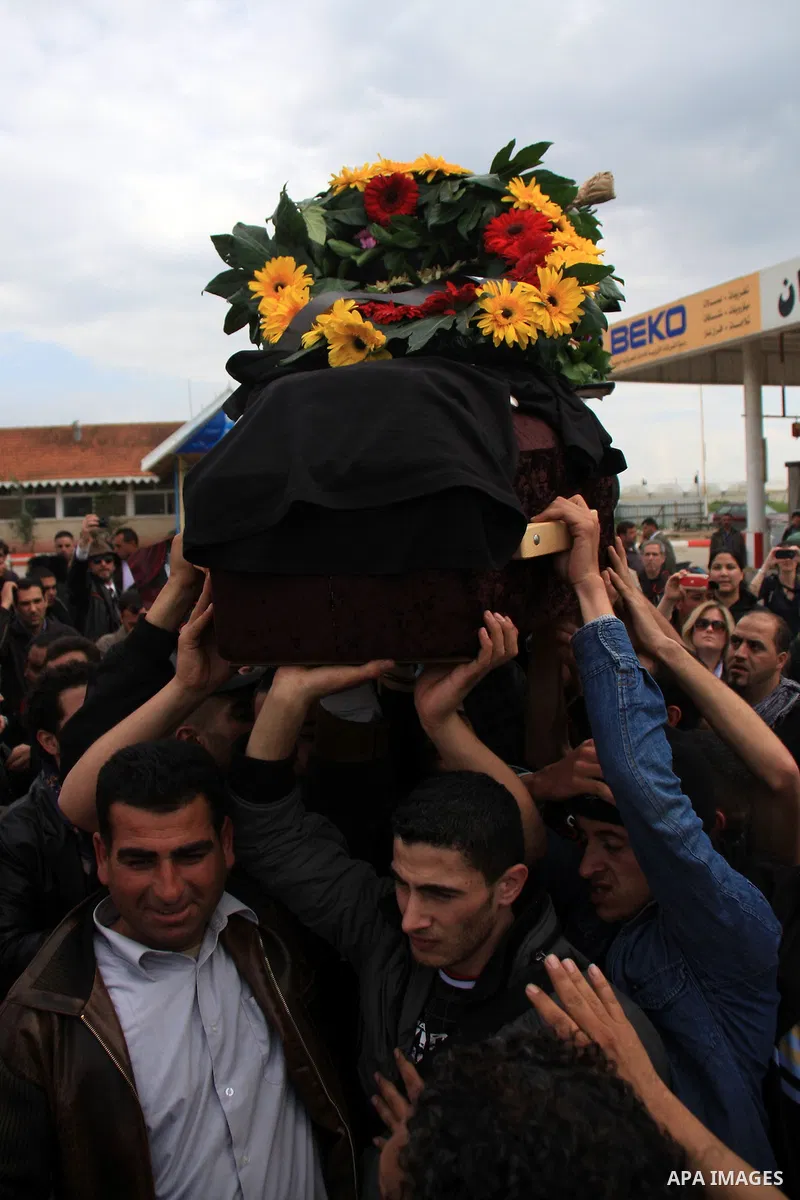 Palestinian Students of Jenin's Freedom Theater weep while waiting for the body of Arab-Israeli actor and director Juliano Mer-Khamis during his funeral at al Jalama Israeli checkpoint between Hayfa City and the West Ban...