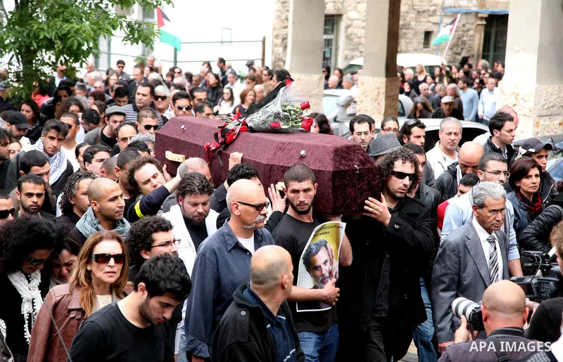 People carry the coffin of Arab-Israeli actor and director Juliano Mer Khamis during a funeral procession near al-Midan theater in the northern Israeli city of Haifa April 6, 2011. Mer-Khamis was gunned down Monday in th...
