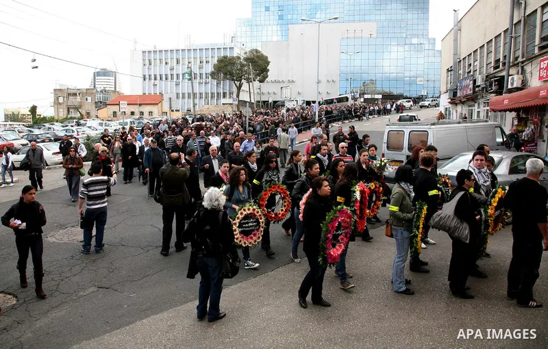 People carry the coffin of Arab-Israeli actor and director Juliano Mer Khamis during a funeral procession near al-Midan theater in the northern Israeli city of Haifa April 6, 2011. Mer-Khamis was gunned down Monday in th...