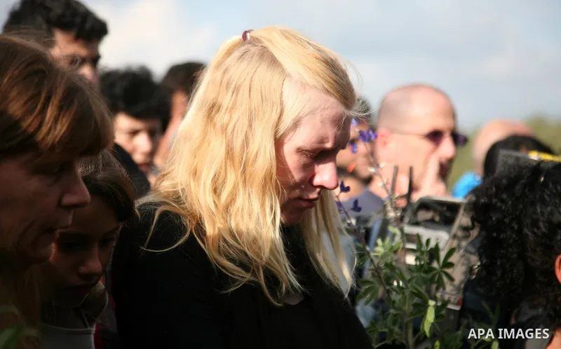 The wife of Arab-Jewish actor and theatre director Juliano Mer-Khamis is cheered up by a relative during her husbands' funeral procession in Haifa, northern Israel, Wednesday, April 6, 2011. Mer-Khamis was gunned down Mo...