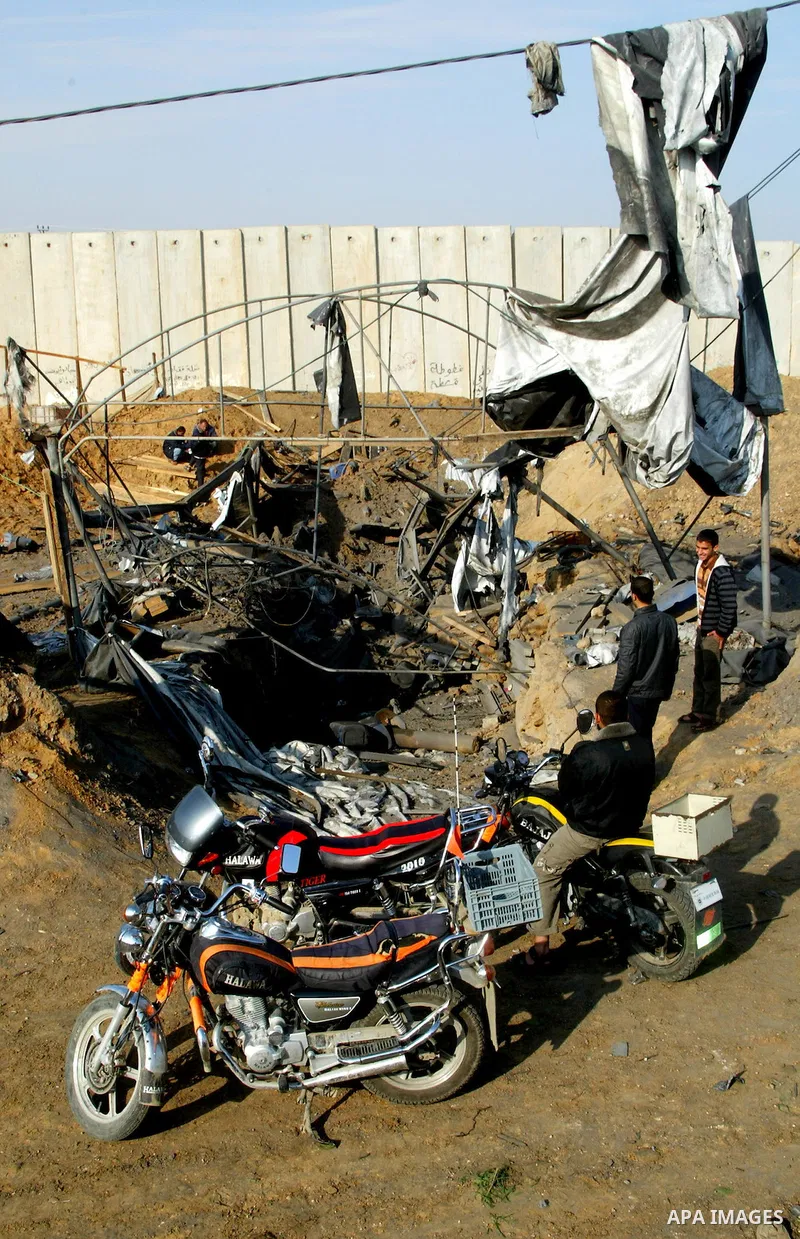 Palestinian men inspect damages at smuggling tunnels which were targeted by Israeli air strikes overnight in Rafah in the south of the Gaza Strip at the border with Egypt on April 7, 2011. Photo By Abed Rahim Khatib