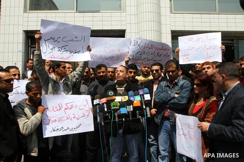 Palestinian journalists take part in a rally in front of the mobile company (jawwal) against the high prices and the bad services of the company in Gaza city on April 7,2011. Photo by Ashraf Amra