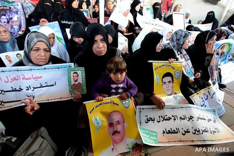 Palestinians hold pictures of jailed relatives during a protest in Gaza city calling for their release from Israeli prisons on April 7, 2011. Photo by Ashraf Amra