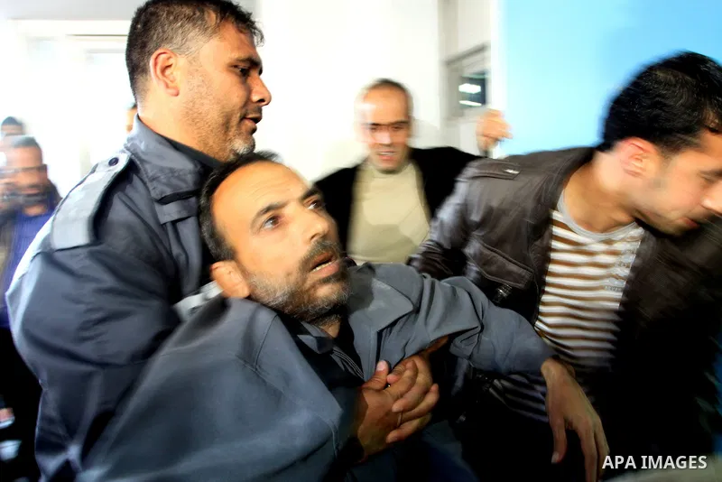 A wounded Palestinian man is carried by his relatives at the al-Shifa hospital after his house was hit by Israeli shell fired towards Gaza Strip near the border between eastern Gaza city and Israel, Wednesday, April 7, 2...