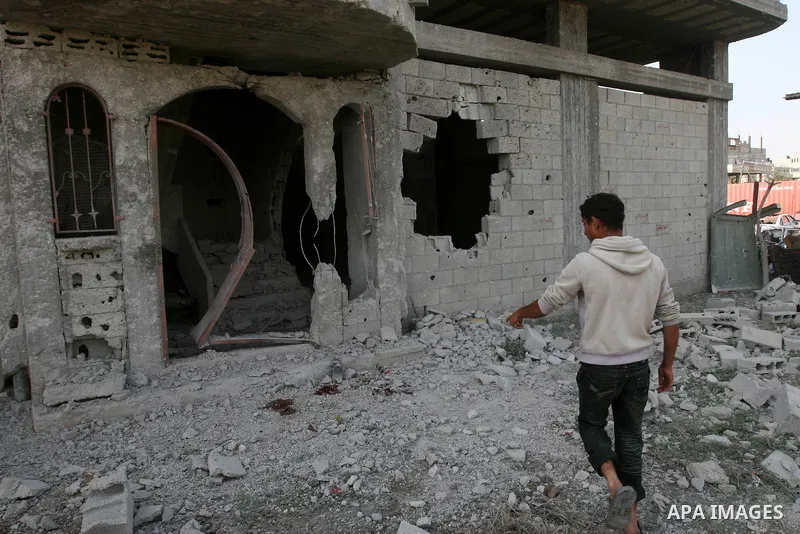 Palestinian children stand next the damaged house after an Israeli airstrike east of Gaza City, Thursday, April 7, 2011. An anti-tank missile fired from the Gaza Strip struck a school bus in southern Israel Thursday, wou...