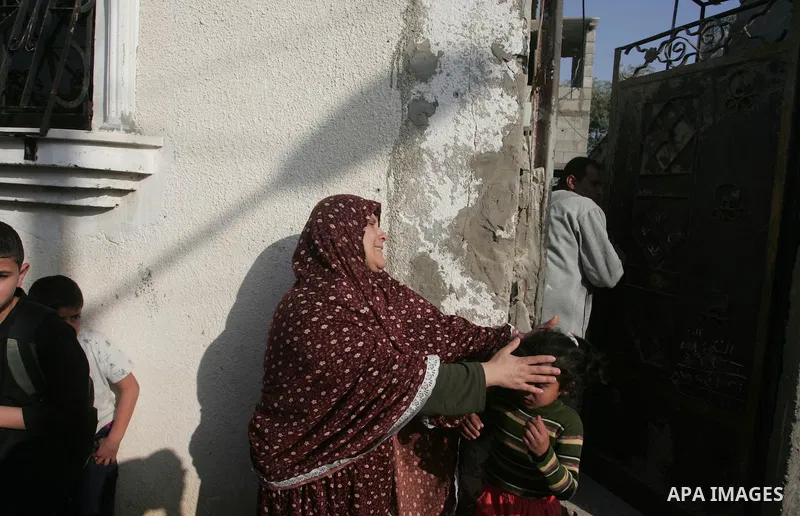 A Palestinian woman cries after her house was destroyed in an explosion that hit the nearby Hamas police training camp in Beit Lahia on April 7, 2011 after Israeli troops shelled two separate areas in Gaza, killing one p...