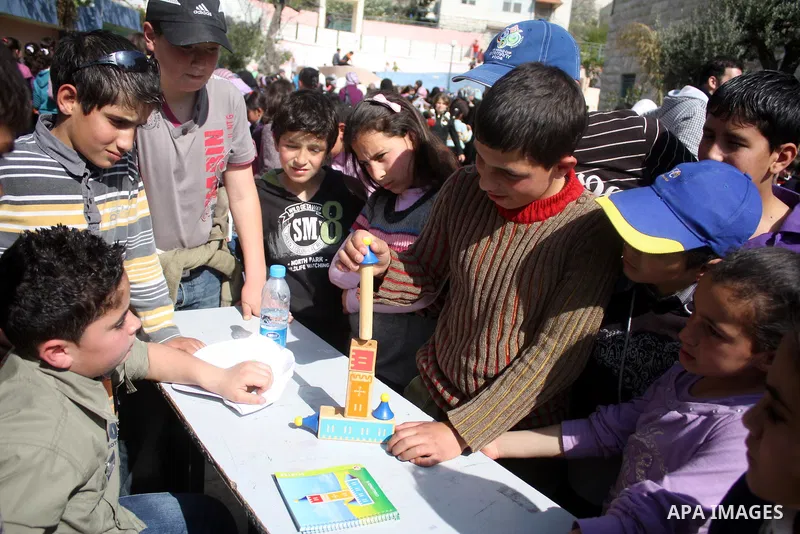 Palestinian children take part in playing festival ( All Together with Children) at Child Happiness Center in the West Bank city of Hebron,on April 07, 2011.Photo by Najeh Hashlamoun