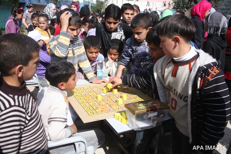 Palestinian children take part in playing festival ( All Together with Children) at Child Happiness Center in the West Bank city of Hebron,on April 07, 2011.Photo by Najeh Hashlamoun