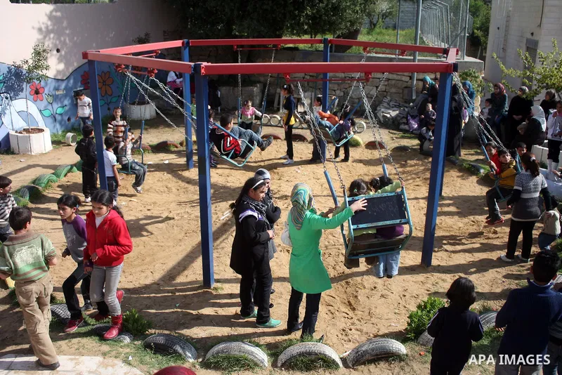 Palestinian children take part in playing festival ( All Together with Children) at Child Happiness Center in the West Bank city of Hebron,on April 07, 2011.Photo by Najeh Hashlamoun