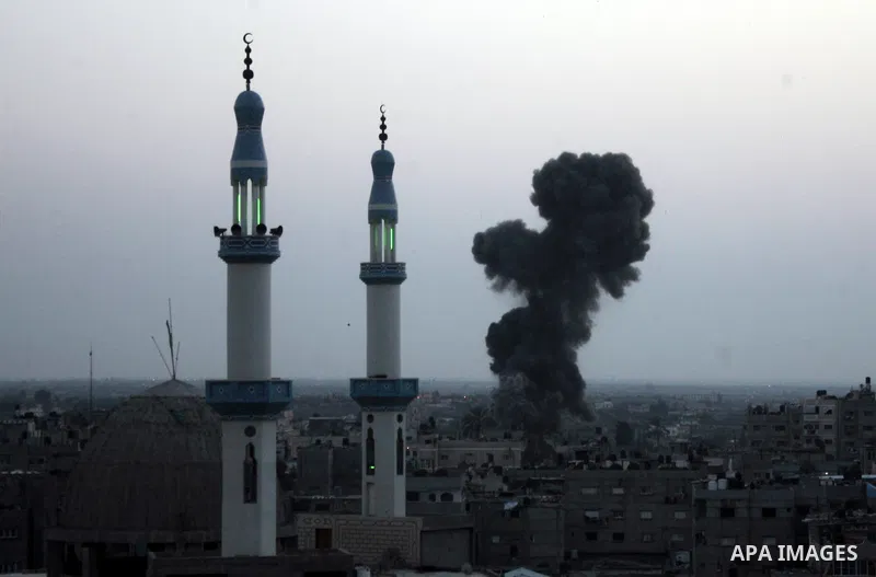 Smoke billows behind buildings from smuggling tunnels linking the southern Gaza Strip to Egypt targeted by an Israeli raid in the town of Rafah on April 7, 2011 killing two people and wounding 14. The shelling came short...