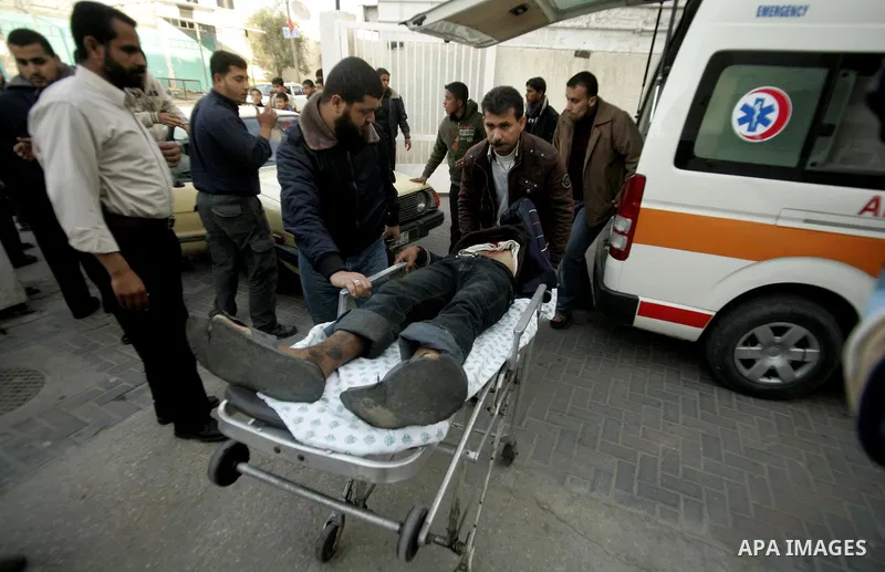 A wounded Palestinian is wheeled at al-Najar hospital in the southern Gaza Strip town of Rafah on April 7, 2011 after Israeli troops shelled two separate areas in Gaza, killing one person and wounded at least 10. Photo b...