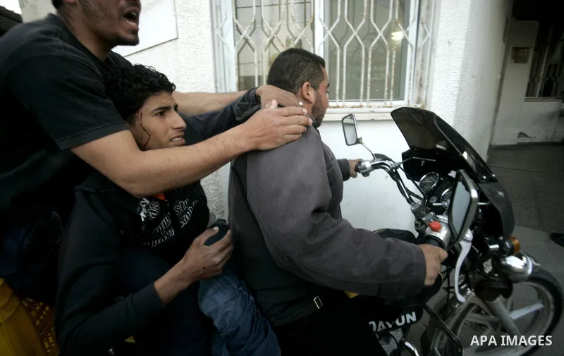 A wounded Palestinian is wheeled at al-Najar hospital in the southern Gaza Strip town of Rafah on April 7, 2011 after Israeli troops shelled two separate areas in Gaza, killing one person and wounded at least 10. Photo b...