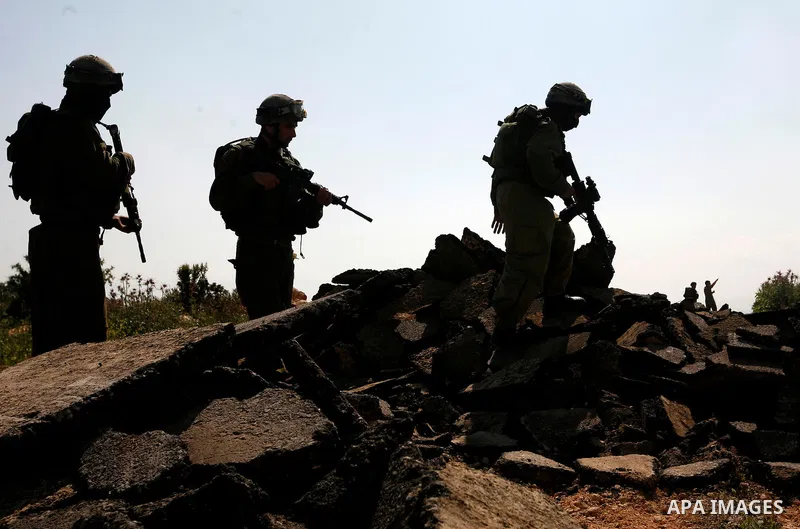 An Israeli earth-mover destroys a main road in Aqaba near the West Bank village of Tubas in the northern Jenin region on April 7, 2011 as the military used bulldozers to destroy Palestinian houses in another farming vill...