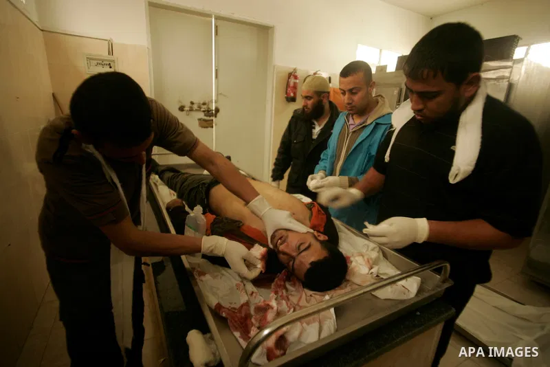 Palestinian youths check the body of a man killed by Israeli tank shell yesterday, at a morgue in al-Najar hospital in the southern Gaza Strip town of Rafah on April 8, 2011. Palestinian officials in Gaza reported that t...