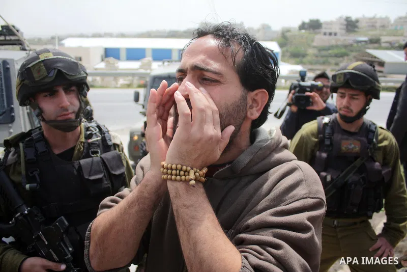 Protesters argue with an Israeli soldier during a demonstration against Israel's controversial separation barrier in the West Bank village of Maasarah, near the biblical town of Bethlehem on April 08, 2011.Israel says th...