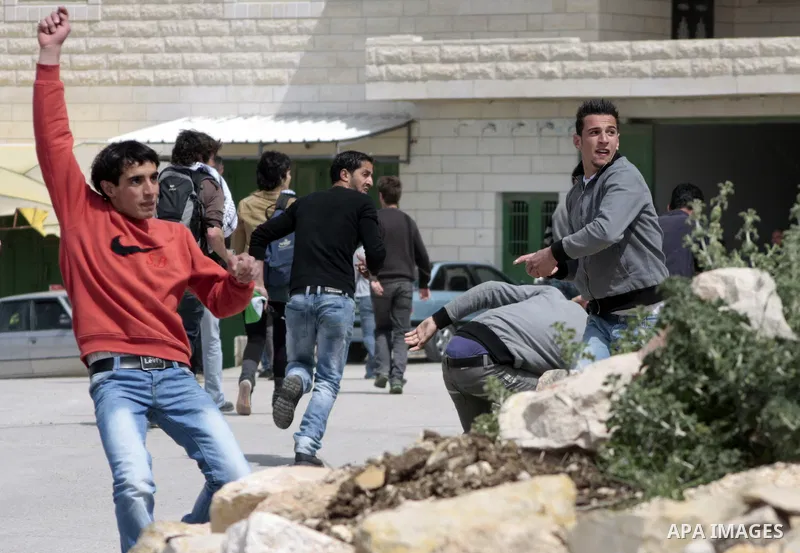 Protesters hurl stones towards Israeli soldiers during a demonstration against Israel's controversial separation barrier in the West Bank village of Maasarah, near the biblical town of Bethlehem on April 08, 2011.Israel...