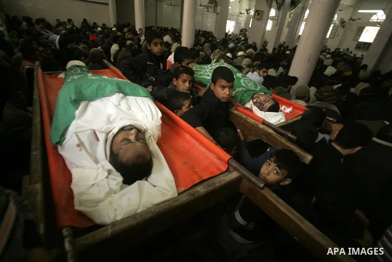 Palestinians pray next to bodies of Hamas militants during their funeral in Rafah in the southern Gaza Strip April 8, 2011. Israeli air strikes in the Gaza Strip killed two militants from the Islamist group Hamas and thr...