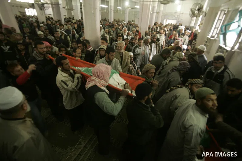 Palestinians pray next to bodies of Hamas militants during their funeral in Rafah in the southern Gaza Strip April 8, 2011. Israeli air strikes in the Gaza Strip killed two militants from the Islamist group Hamas and thr...