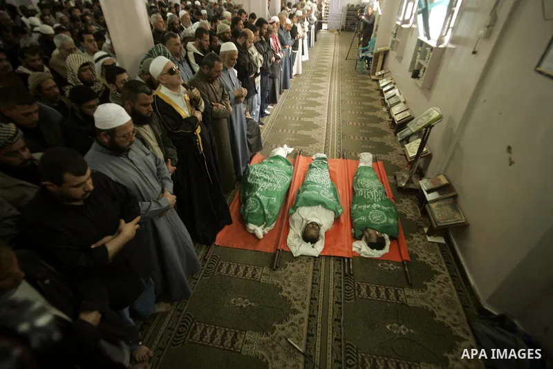 Palestinians pray next to bodies of Hamas militants during their funeral in Rafah in the southern Gaza Strip April 8, 2011. Israeli air strikes in the Gaza Strip killed two militants from the Islamist group Hamas and thr...