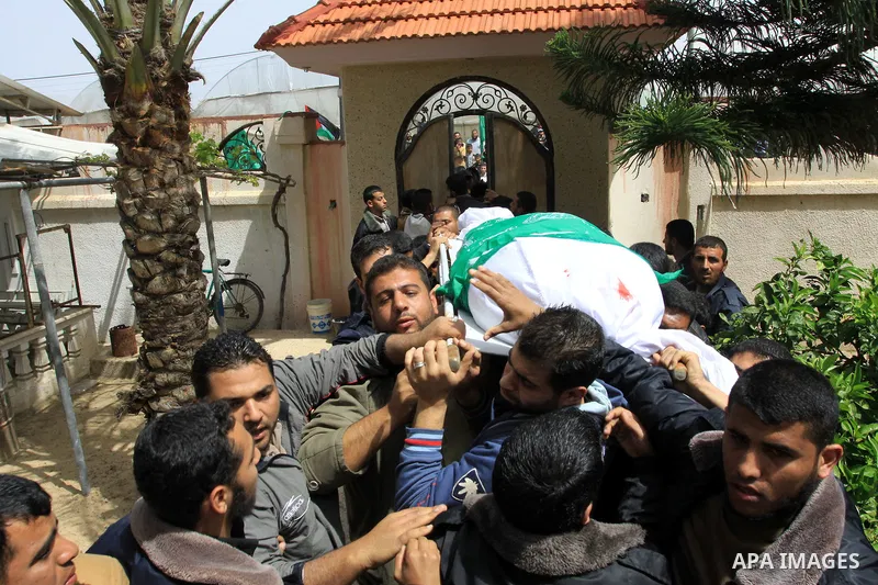 Palestinian mourners carry the body of Motaz Abu Jameh during his funeral in the southern Gaza Strip town of Khan Yunis on April 8, 2011 after Israeli warplanes pounded the coastal strip, killing at least three civilians...